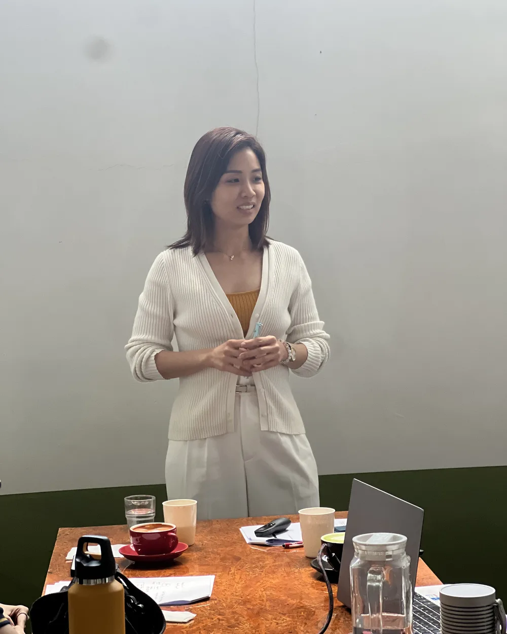 May, a pilates studio owner, speaking to the room